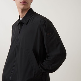 Model wearing Hugo Boss Orange black casual shirt jacket with zip fastening and collar, relaxed fit in polyamide blend fabric