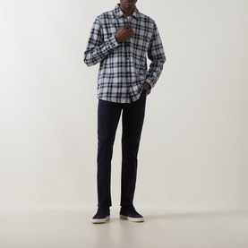 Model wearing Hugo Boss Orange Locky 2 Check Overshirt in open grey check, styled with navy trousers and dark trainers