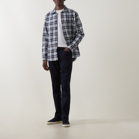 Model wearing Hugo Boss Orange Locky 2 Check Overshirt in open grey check, styled with white tee and dark navy jeans.