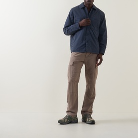 Model wearing Hugo Boss Orange Lody Regular Fit Overshirt in dark blue with concealed button placket, styled with taupe cargo trousers and trail