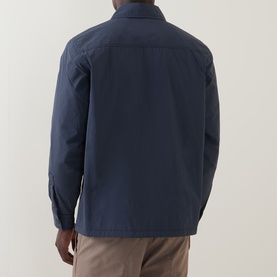 Model wearing Hugo Boss Orange Lody Regular Fit Overshirt in dark blue, back view, styled with stone chinos