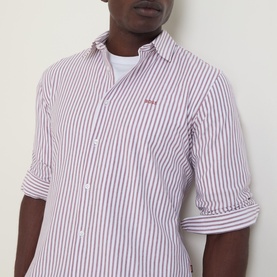 Model wearing Hugo Boss Orange Mysoft Logo Striped Shirt in medium red and white stripes, with small chest logo and rolled sleeves.