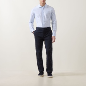 Model wearing Hugo Boss Orange Mysoft Stripe Shirt in Open Blue with navy trousers and white trainers.