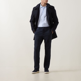 Model wearing Hugo Boss Orange Mysoft Stripe Shirt in Open Blue, styled with navy coat, matching trousers and grey suede shoes.