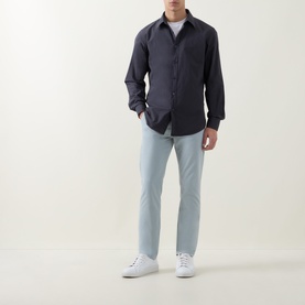 Model wearing Hugo Boss Orange Relegant Logo Casual Shirt in dark blue with light wash jeans and white trainers