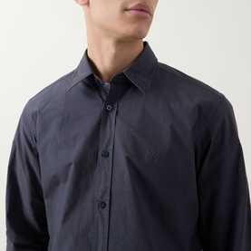 Model wearing Hugo Boss Orange Relegant Logo Casual Shirt in dark blue, featuring Kent collar, front button placket, and tonal chest logo embroidery