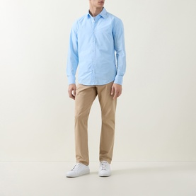Model wearing Hugo Boss Orange Relegant Logo Casual Shirt in Open Blue with beige chinos and white trainers