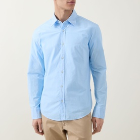 Model wearing Hugo Boss Orange Relegant Logo Casual Shirt in Open Blue, long sleeves, front button placket, styled with beige trousers