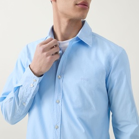 Model wearing Hugo Boss Orange Relegant Logo Casual Shirt in Open Blue, showing kent collar and front button placket, styled over white T-shirt