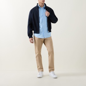 Model wearing Hugo Boss Orange Relegant Logo Casual Shirt in Open Blue, styled with navy bomber jacket, beige chinos and white trainers.