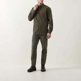 Model wearing Hugo Boss Orange Bright Green cotton casual shirt with matching olive trousers and dark hiking boots