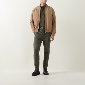 Model wearing Hugo Boss Orange Bright Green cotton casual shirt, styled with tan bomber jacket, khaki trousers and brown lace-up boots.