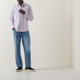 Model wearing Hugo Boss Orange Relegant Tonal Logo Shirt in Medium Red, long sleeves, button fastenings, styled with blue jeans and navy trainers