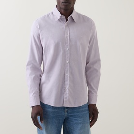Model wearing Hugo Boss Orange Relegant Tonal Logo Shirt in Medium Red, long sleeves, pointed collar, button fastenings, styled with blue jeans