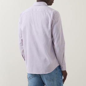 Model wearing Hugo Boss Orange Relegant Tonal Logo Shirt in Medium Red, back view, with light blue jeans. Long sleeves, pointed collar.