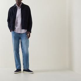 Model wearing Hugo Boss Orange Relegant Tonal Logo Shirt in Medium Red with navy jacket, light blue jeans and navy slip-on shoes