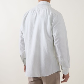 Model wearing Hugo Boss Orange casual shirt in Open Green, rear view, fine stripe texture, long sleeves, styled with taupe trousers
