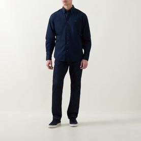 Model wearing Hugo Boss Orange Ricoplus Logo Casual Shirt in dark blue, styled with navy trousers and light grey trainers