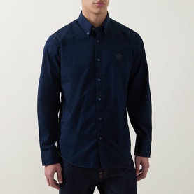 Model wearing Hugo Boss Orange Ricoplus Logo Casual Shirt in dark blue, button-down collar, long sleeves, logo patch, styled with dark jeans