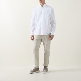 Model wearing Hugo Boss Orange Ricoplus Logo Casual Shirt in white with button-down collar, styled with stone chinos and grey trainers.