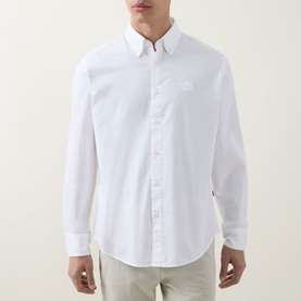 Model wearing Hugo Boss Orange Ricoplus Logo Casual Shirt in white, button-down collar, long sleeves, logo patch, styled with light chinos