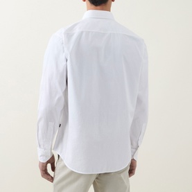 Model wearing Hugo Boss Orange Ricoplus Logo Casual Shirt in white, back view, styled with beige trousers. Long sleeves, curved hem.