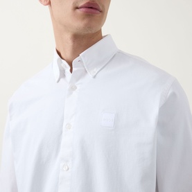 Model wearing Hugo Boss Orange Ricoplus Logo Casual Shirt in white, showing button-down collar and chest logo patch detail