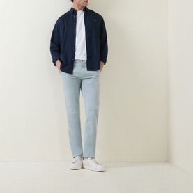 Model wearing Hugo Boss Orange Overdyed Slim-Leg Chinos in Open Grey, styled with a navy overshirt, white tee and white trainers.