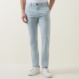 Model wearing Hugo Boss Orange Overdyed Slim-Leg Chinos in Open Grey, styled with a white tee and white trainers.