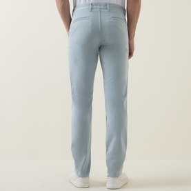 Model wearing Hugo Boss Orange Overdyed Slim-Leg Chinos in Open Grey, slim-leg fit, shown from rear with white trainers