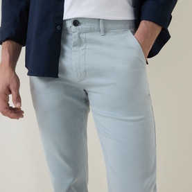 Model wearing Hugo Boss Orange Overdyed Slim-Leg Chinos in Open Grey, styled with a white tee and navy jacket