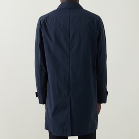 Model wearing Hugo Boss Clark Water Repellent Coat in dark blue, rear view showing clean back seam and snap button cuffs.