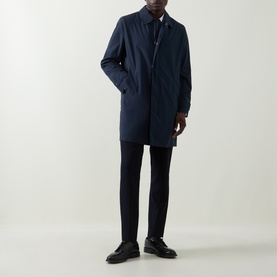 Model wearing Hugo Boss Clark Water Repellent Coat in dark blue with concealed zip placket, styled with navy trousers and black shoes.