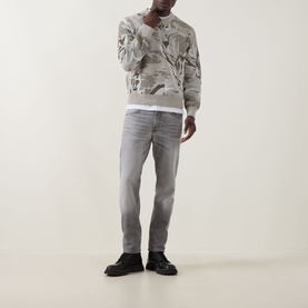 Model wearing Hugo Boss Orange Afloralo Jacquard Relaxed Fit Sweater in light beige with grey jeans and black boots