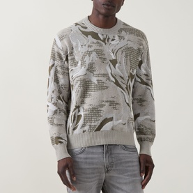 Model wearing Hugo Boss Orange Afloralo Jacquard Relaxed Fit Sweater in Light Beige with floral pattern, styled with grey jeans