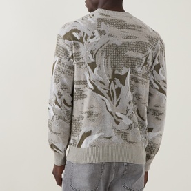 Model wearing Hugo Boss Orange Afloralo Jacquard Relaxed Fit Sweater in light beige with camo-style jacquard pattern, ribbed cuffs, back view