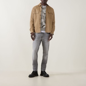 Model wearing Hugo Boss Orange Afloralo Light Beige jacquard crew neck sweater, styled with tan overshirt and grey slim jeans
