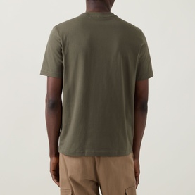 Model wearing Hugo Boss Orange Bright Green cotton crew neck T-shirt, back view, styled with stone chino trousers