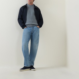 Model wearing Hugo Boss Orange Arkingo Texture Rib Sweater in Open Grey, styled with navy jacket, light blue jeans and navy trainers.