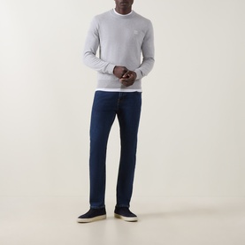 Model wearing Hugo Boss Orange Kanovano Logo Regular Fit Sweater in Open Grey, styled with dark indigo jeans and navy trainers.