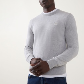 Model wearing Hugo Boss Orange Kanovano Logo Regular Fit Sweater in Open Grey, crew neck with logo patch, styled over white top