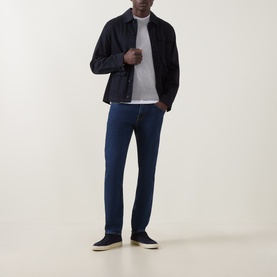 Model wearing Hugo Boss Orange Kanovano Open Grey crew neck sweater, styled with dark navy jacket, blue jeans and navy trainers.
