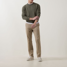 Model wearing Hugo Boss Orange Kanovano Logo Sweater in Bright Green with crew neck, styled with beige chinos and white trainers