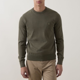 Model wearing Hugo Boss Orange Kanovano Logo Sweater in Bright Green, crew neck with ribbed trims and chest logo patch, styled with beige trousers