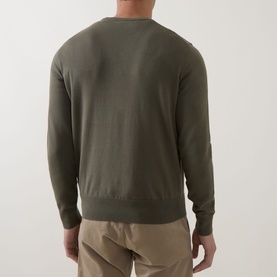 Model wearing Hugo Boss Orange Kanovano Logo Sweater in Bright Green, crew neck with ribbed trims, back view, styled with beige trousers