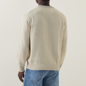 Model wearing Hugo Boss Orange Kosido Light Beige knitted crew neck sweater, back view, styled with blue jeans