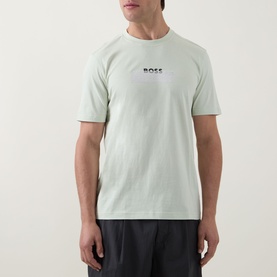Model wearing Hugo Boss Orange Open Green crew neck T-shirt in 100% cotton, with small chest logo print, paired with dark trousers.