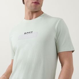 Model wearing Hugo Boss Orange Open Green crew neck T-shirt with raised chest logo box print detail.