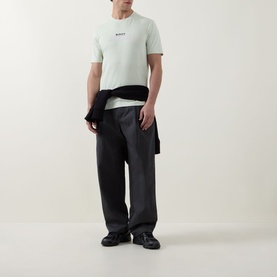 Model wearing Hugo Boss Orange Open Green crew neck T-shirt with dark charcoal trousers and black loafers, jacket tied at waist