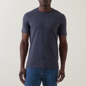 Model wearing Hugo Boss Orange Tales Logo T-Shirt in dark blue, featuring crew neck, subtle chest logo patch and short sleeves, styled with blue